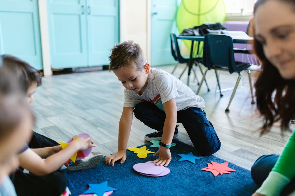 A child crawling through a play tunnel in a living-room obstacle course